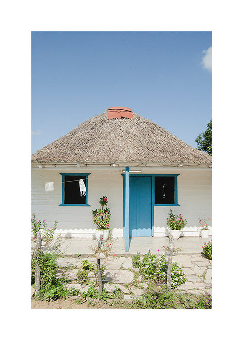 Tableau paysager: maison à porte bleue