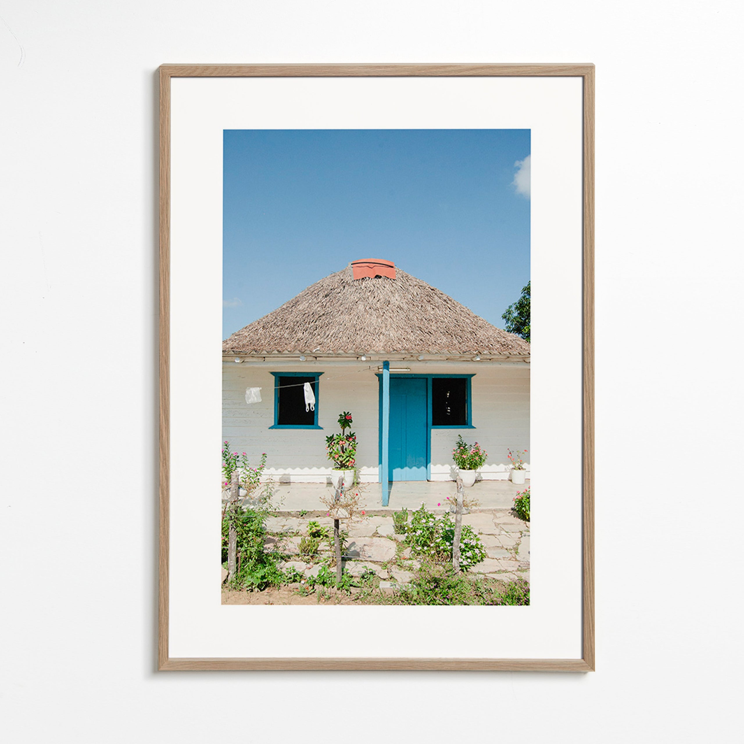 Tableau paysager: maison à porte bleue